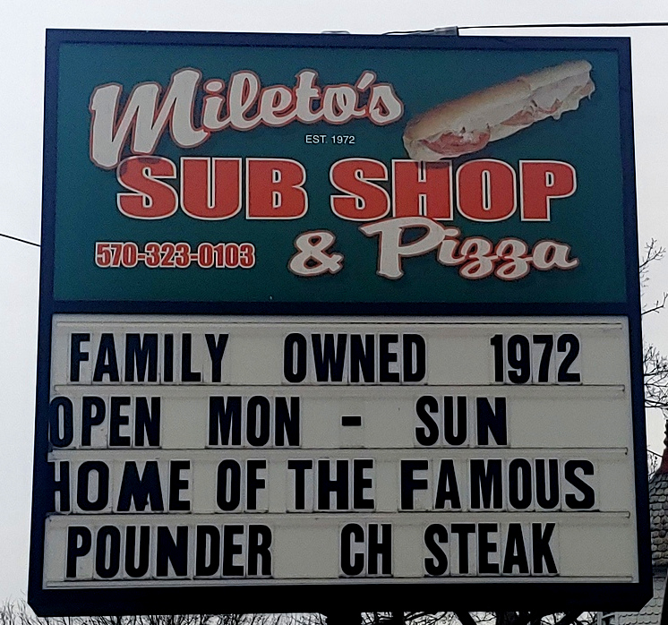 Roadside sign: Mileto's Sub Shop. 