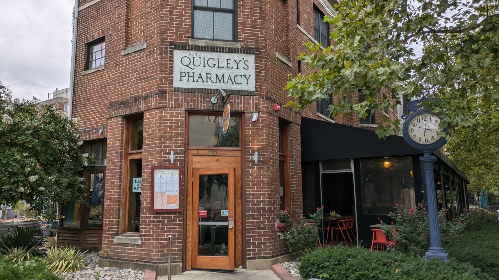 Front entrance, with a "Quigley's Pharmacy" sign above the door.