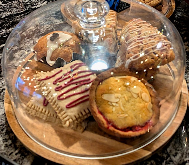 Pastries under a glass dome.