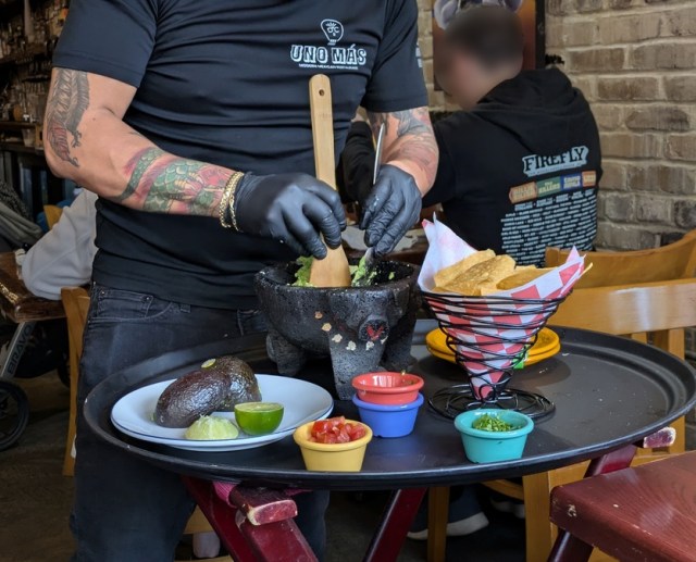 Waiter mxing Guacamole
